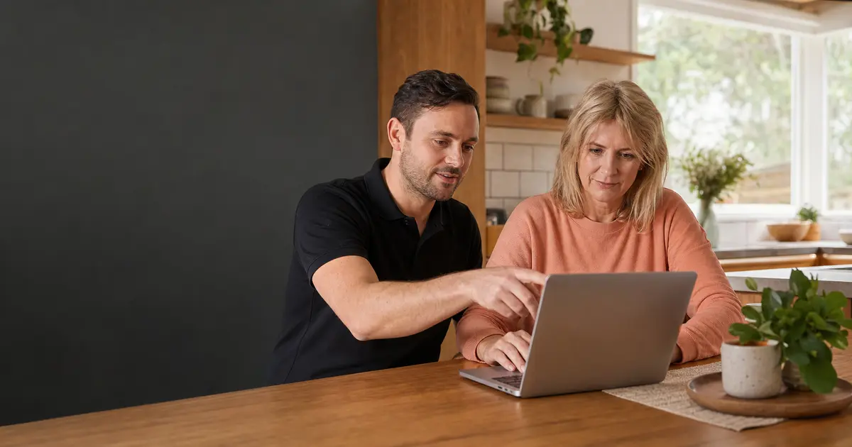Homeowner using her laptop while a technician calmly points to the screen beside her